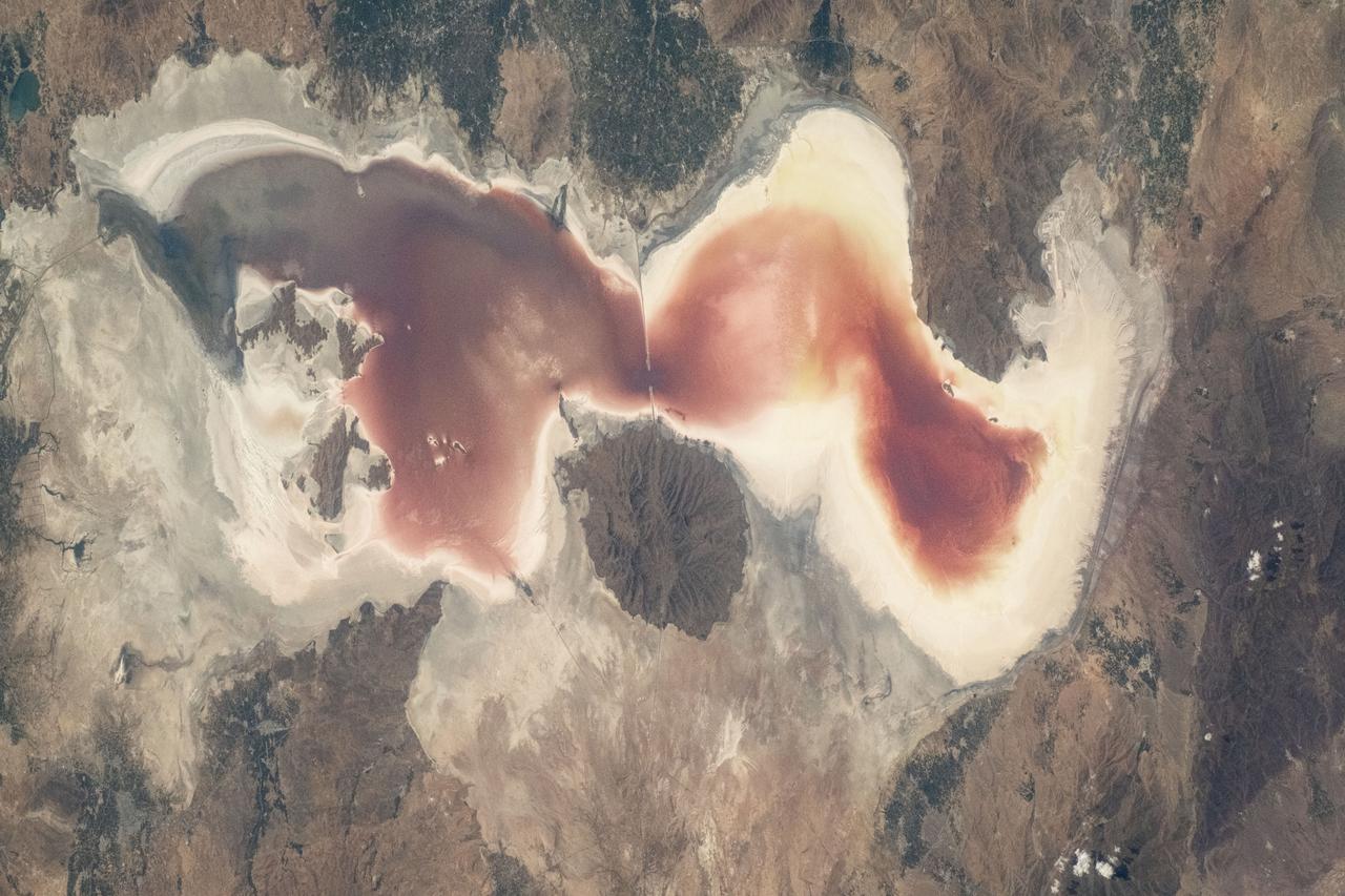 iss071e414494 (Aug. 2, 2024) -- The rich red saltwater of Lake Urmia is pictured from the International Space Station as it orbited 260 miles above. Over the past few decades, the lake has shrunk, causing higher salt concentrations in the water, resulting in microscopic organisms turning the water shades of red and orange.